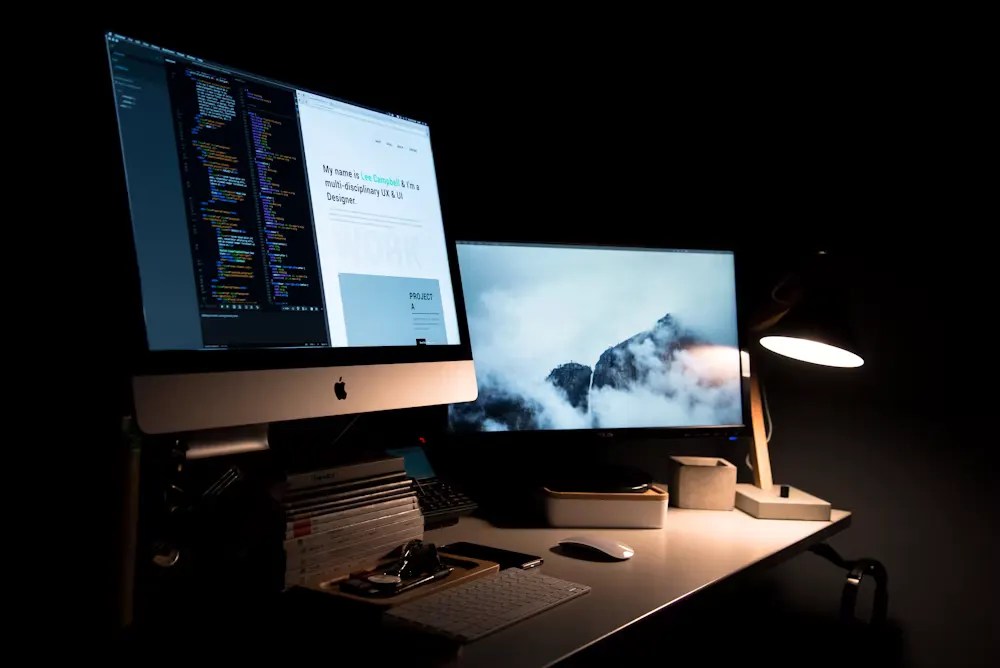 Screens glowing in a dark studio