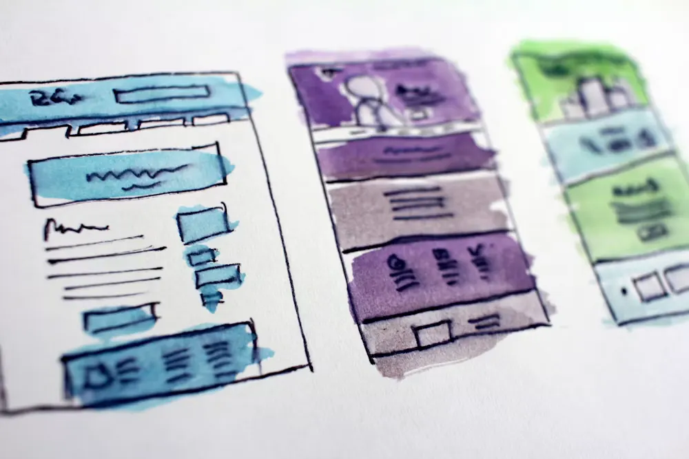 UX wireframes and user flow sketches on a wall