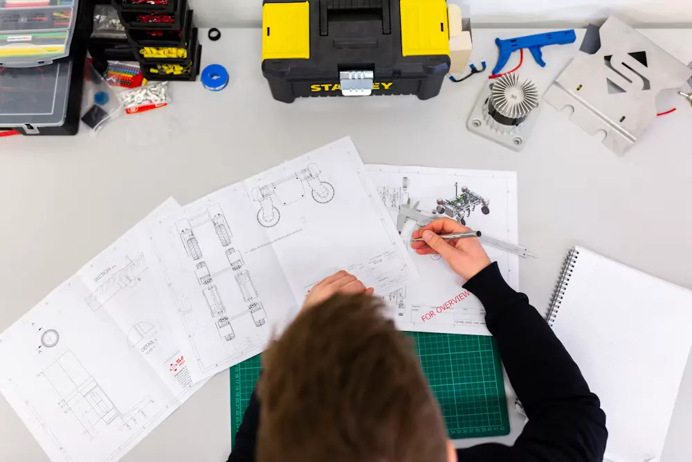 Tools and design sketches on a workbench