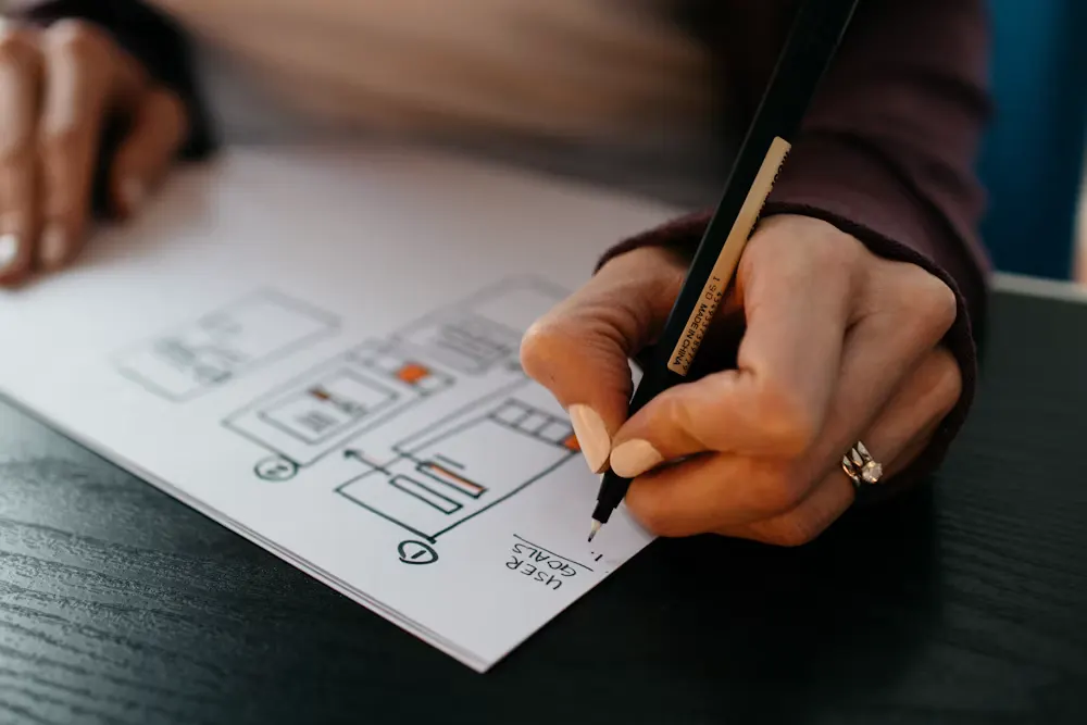 A designer sketching a website wireframe